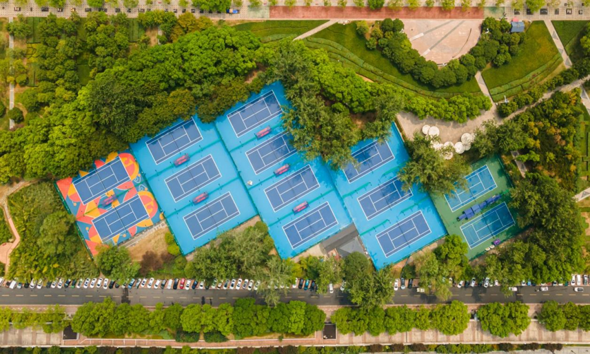 hard court tennis multiple connected courts aerial view