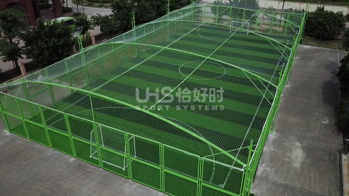 green color fence soccer field with top soft net