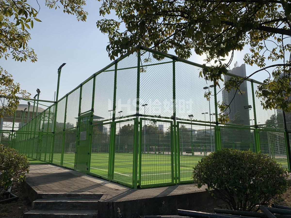 green color fence soccer field on-site photo