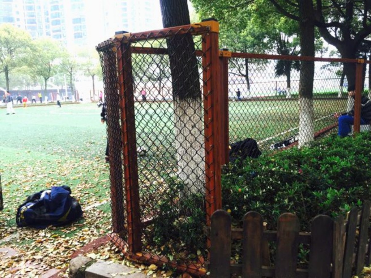 wood grain color park fence surround the football field